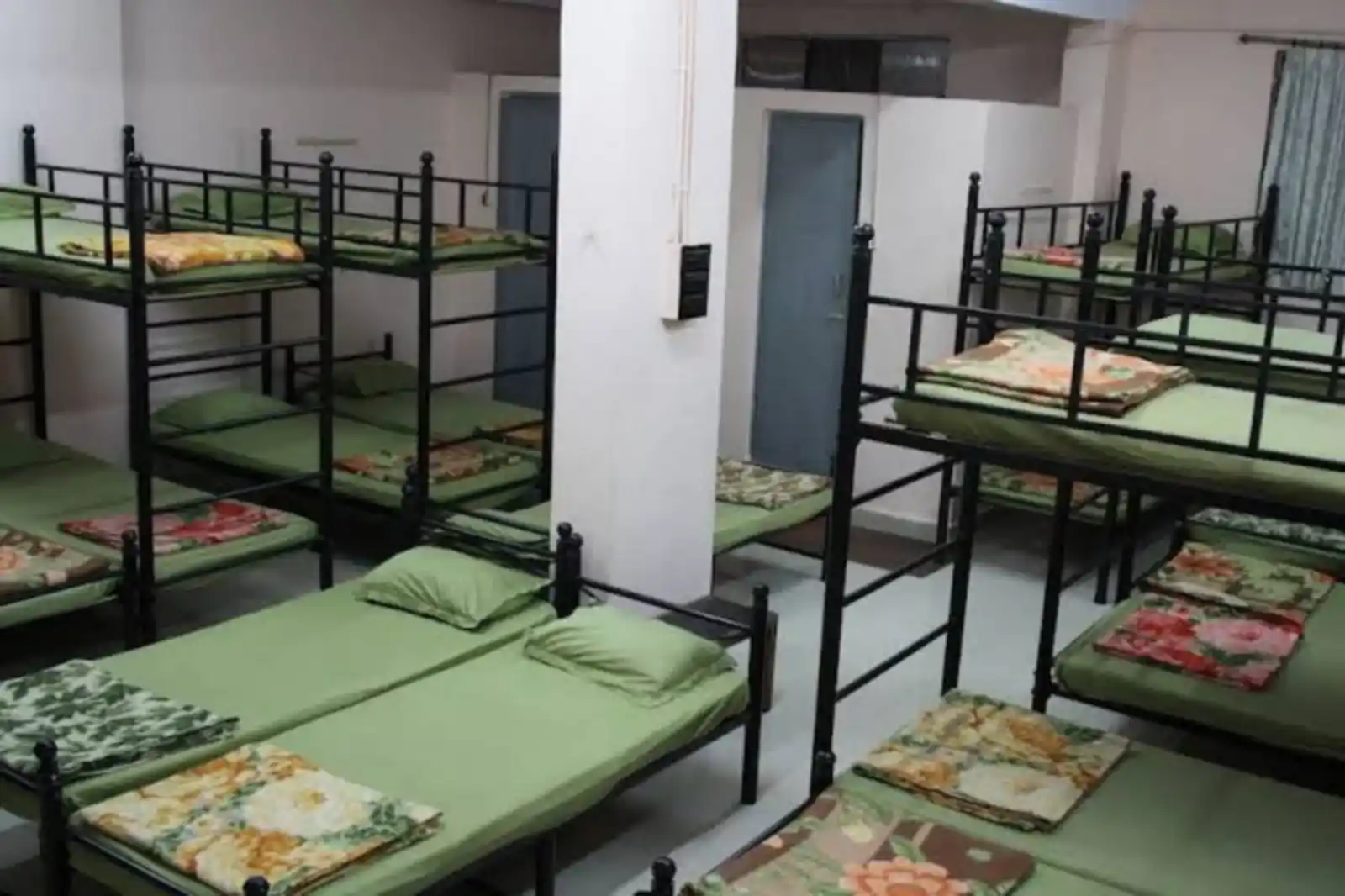 Dormitory bed at Shree Kshetrapal Jain Atithi Bhavan providing budget-friendly shared stay.